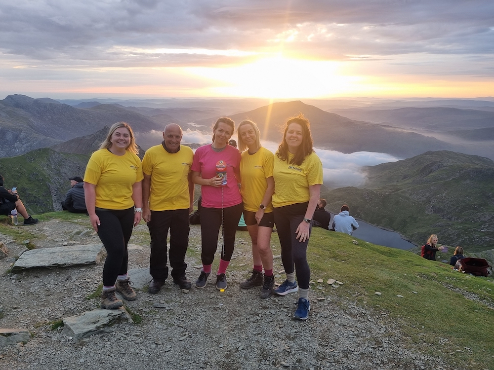 The Pave Aways team at the summit of Yr Wyddfa at sunrise